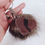 Thumbnail: Brown Black Glitter Resin Heart on Brown Pom Pom Keychain