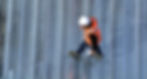 man wearing safety clothing walking on a roof