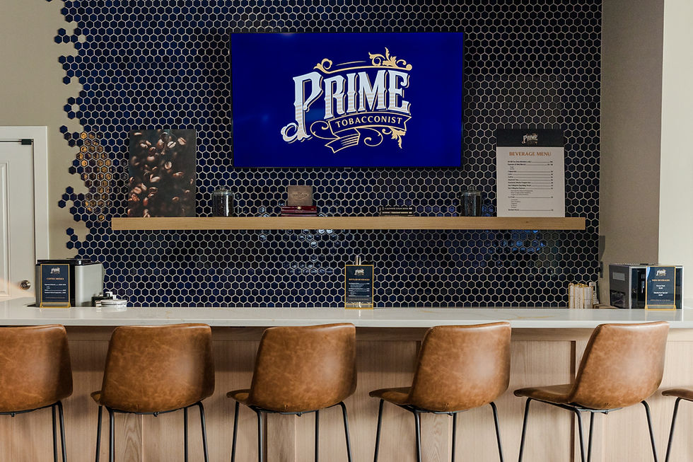 An espresso bar with a white counter top, brown chairs, and a blue honeycomb backsplash