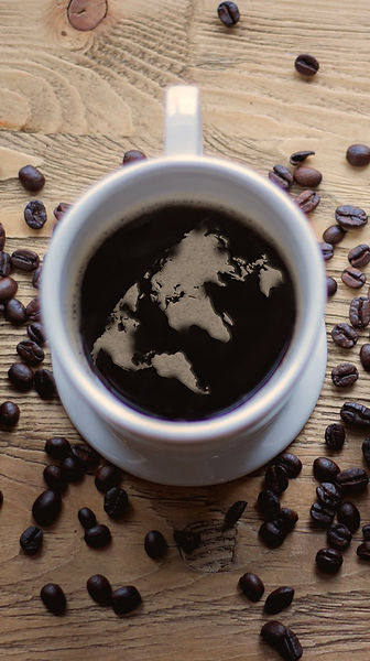 cup of coffee with world map formed in bubbles