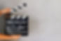 Kid's hand holding film clapper board wi