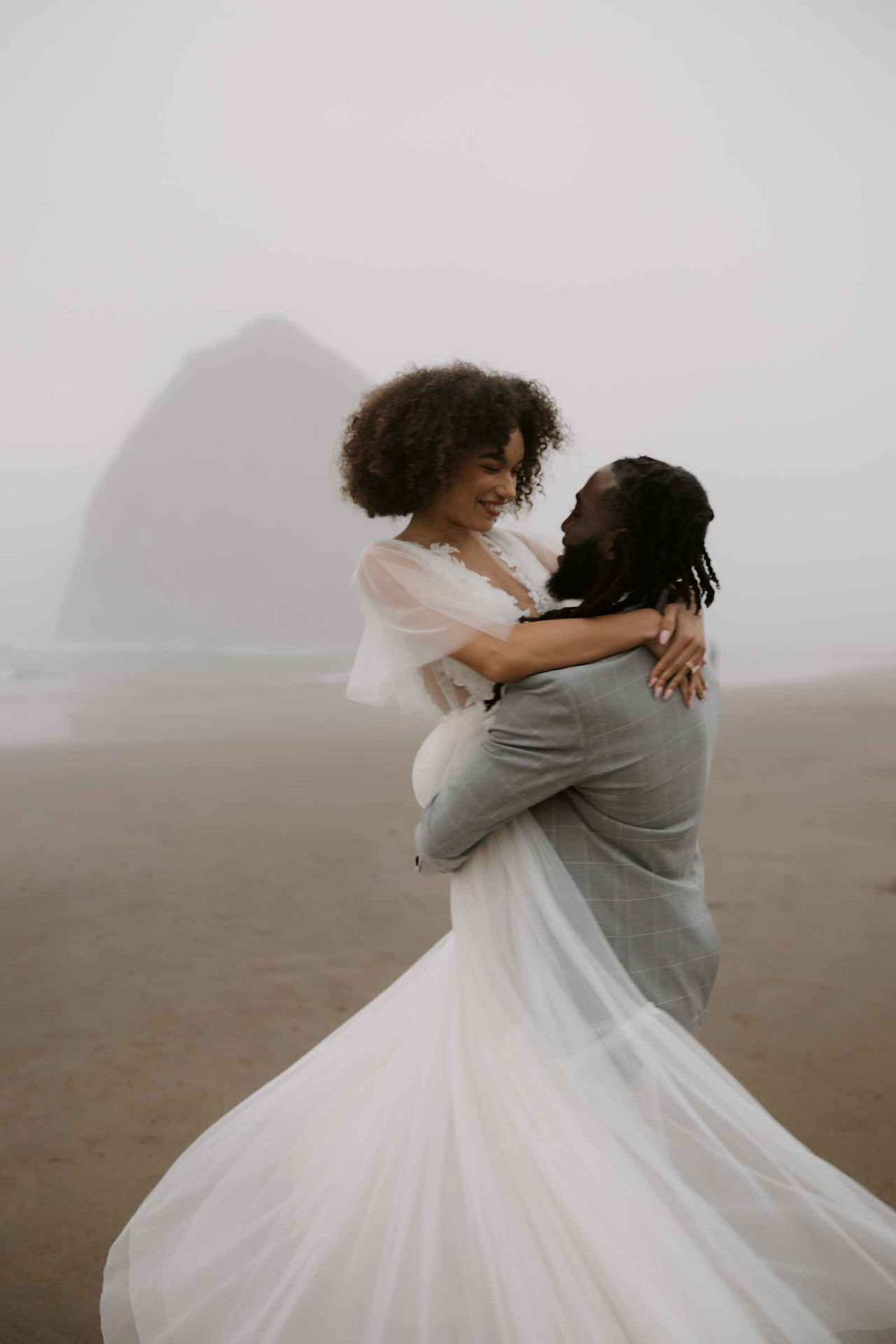 Wedding portraits of couple spinning and smiling.