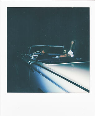 wedding polaroid photo. couple driving away in a vintage car