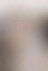 Newlywed couple smiling and laughing surrounded by guests.