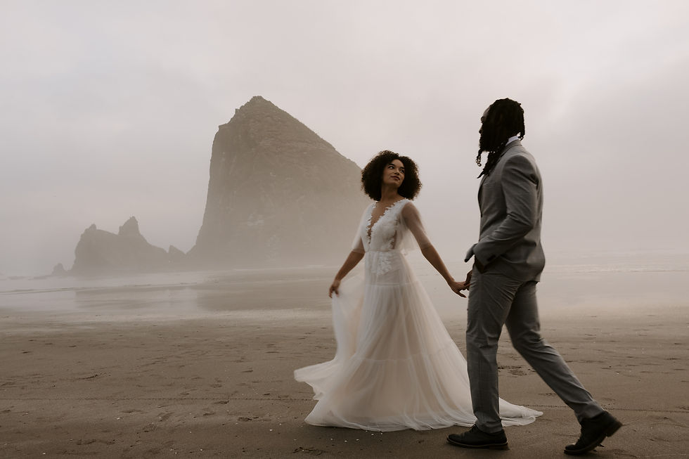 Bride and groom walking along the Oregon Coast at their elopement destination.