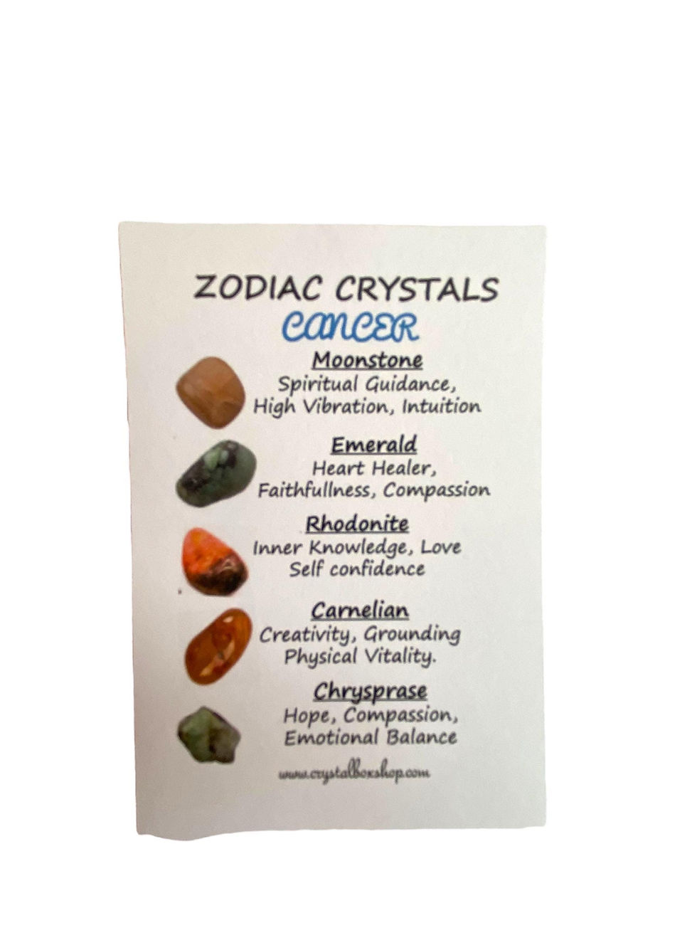 Miniatura: An information card from the Cancer Astrology Crystal Set displayed on a wooden tabletop, from CBS