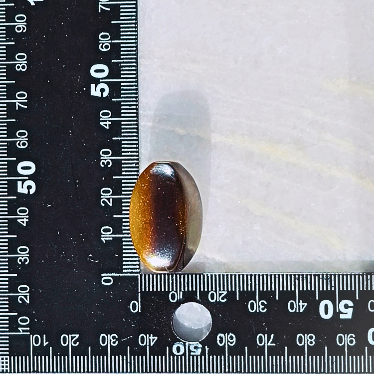 Thumbnail: tigers eye world guru bead with a ruler