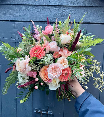 bouquet of peach, cream, coral and green with roses, pompom gerbera, ferns, berries 