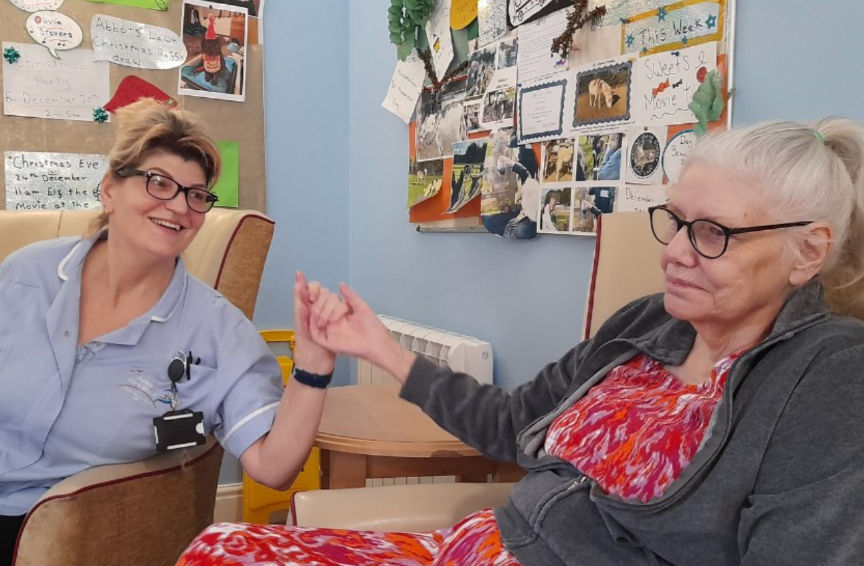 Ashton CareGroup resident holding hands with the carer_edited