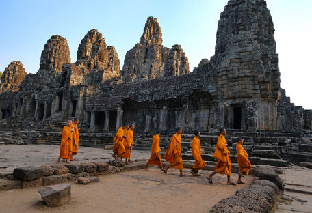 A tourist taking photos in major attraction in Angkor Wat daily.