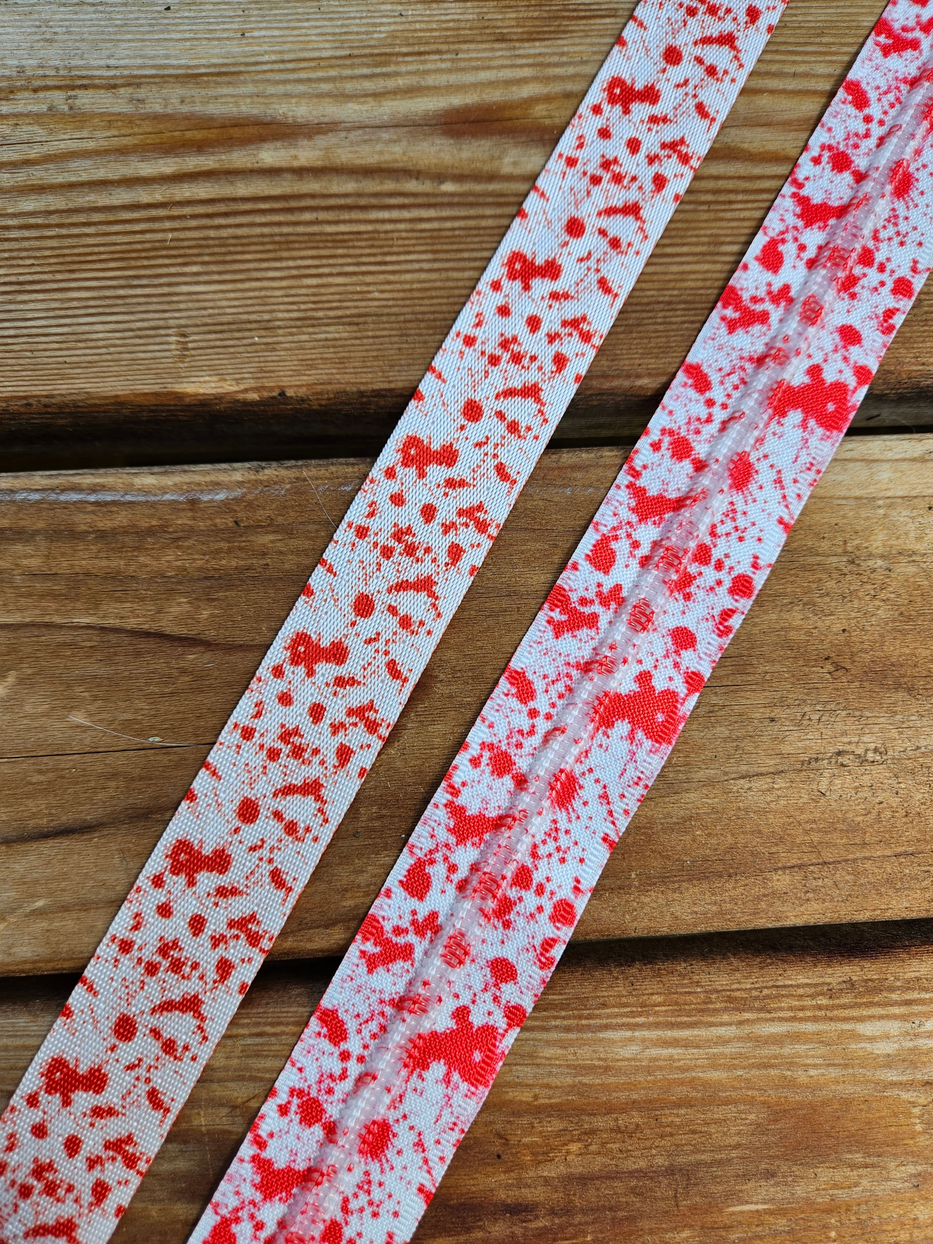 Red splatter on white webbing and tape bundle