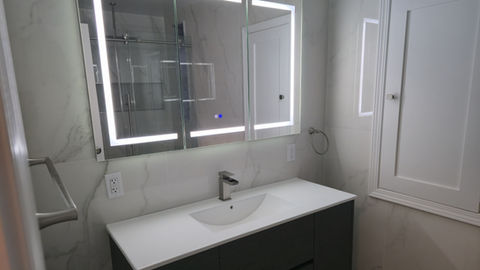 Modern bathroom vanity with illuminated mirrors
