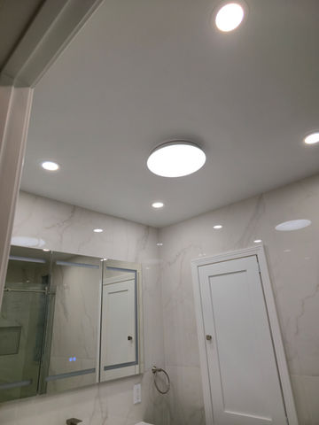 Modern bathroom with ceiling lights and mirrored cabinet