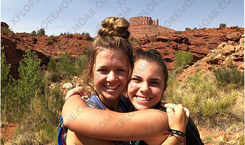 2 teen girls hugging at trailhead of Professor Creek canyon Moab Utah
