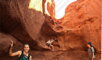 teenagers playing on sandstone walls in Professor Creek canyon Moab Utah
