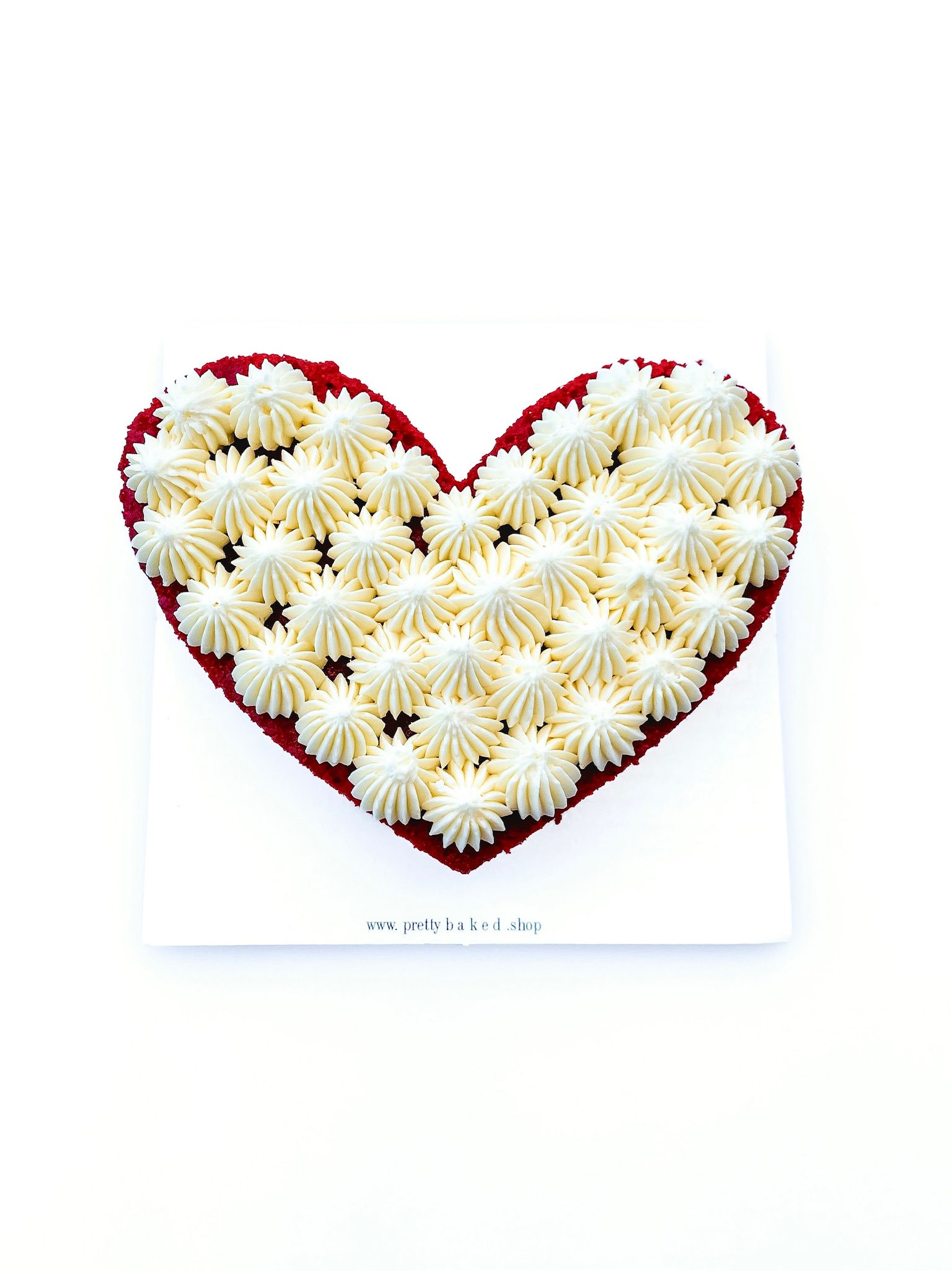 undecorated heart shaped mini sized cake. plain and simple with pretty frosting. Can DIY and add your own decorations.