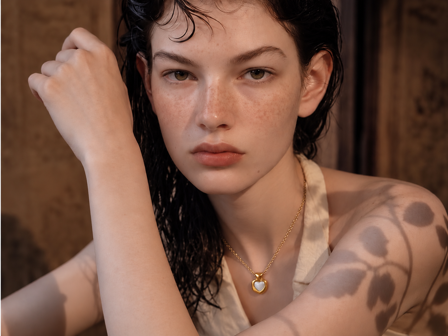 Heart pendant necklace available in gold and silver, model wearing gold heart necklace.