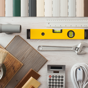 A selection of DIY home renovation tools on a white table