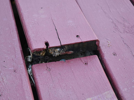 Warped red deck board in Mooresville, NC.