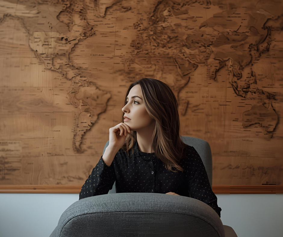 Woman in black shirt in front of a wooden brown map