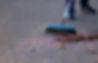 low-section-man-sweeping-street.jpg