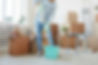 low-section-portrait-happy-young-woman-cleaning-new-house-apartment-while-moving.jpg