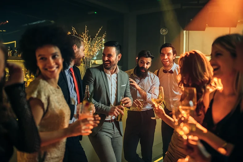 Group of people enjoying a conversation and drinks at apexchange networking mixer.
