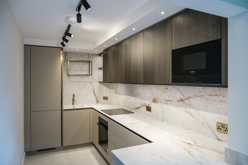Modern handleless kitchen with marble-effect splashback and integrated Siemens appliances in Birmingham loft apartment