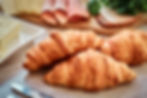 close-up-photo-croissant-with-ham-cheese-butter-wooden-board-kitchen.jpg