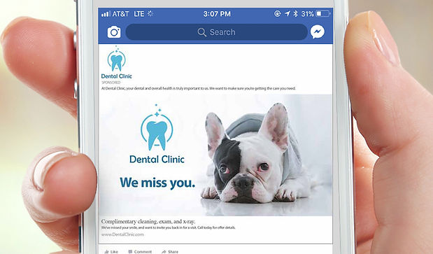 hand holding a cellphone with a targeted facebook ad