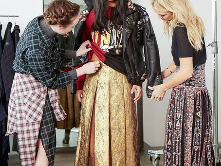 2 female stylists working on styling the model