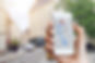 Tourist using GPS map navigation app on smartphone screen to get direction to destination