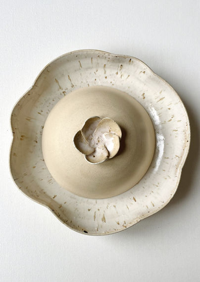 Floral themed cloche dish presented on a flower shaped bowl
