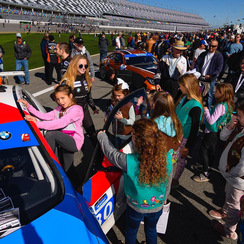 Straus with Girl Scouts brought to the race track through her Girls With Drive program | Credit: Aurora Straus via Facebook