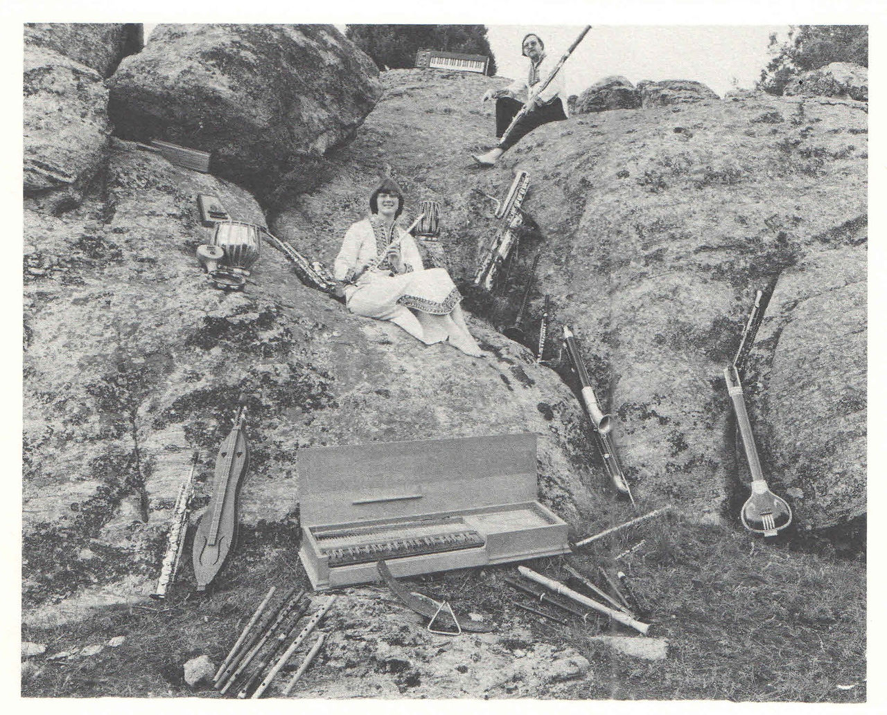 Karen and Alan Leech. 2 musicians and several instruments displayed on rocky landscape