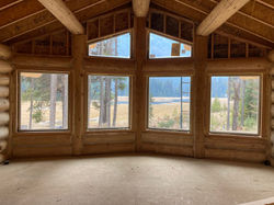custom home interior with large wood windows north idaho