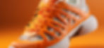 A 3D tennis shoe with orange and white coloring