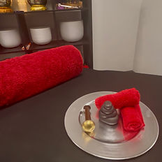 Close-up of red towel setup on massage table in the healing room at Shape Wellness.