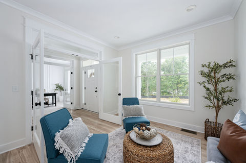Modern living room with two blue armchairs, woven coffee table