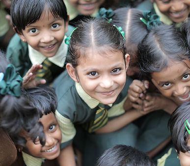 Children smiling up at the camera