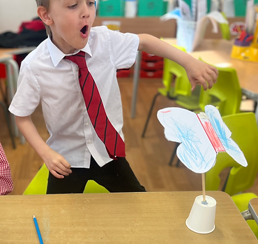 Child smiling with completed STEM project