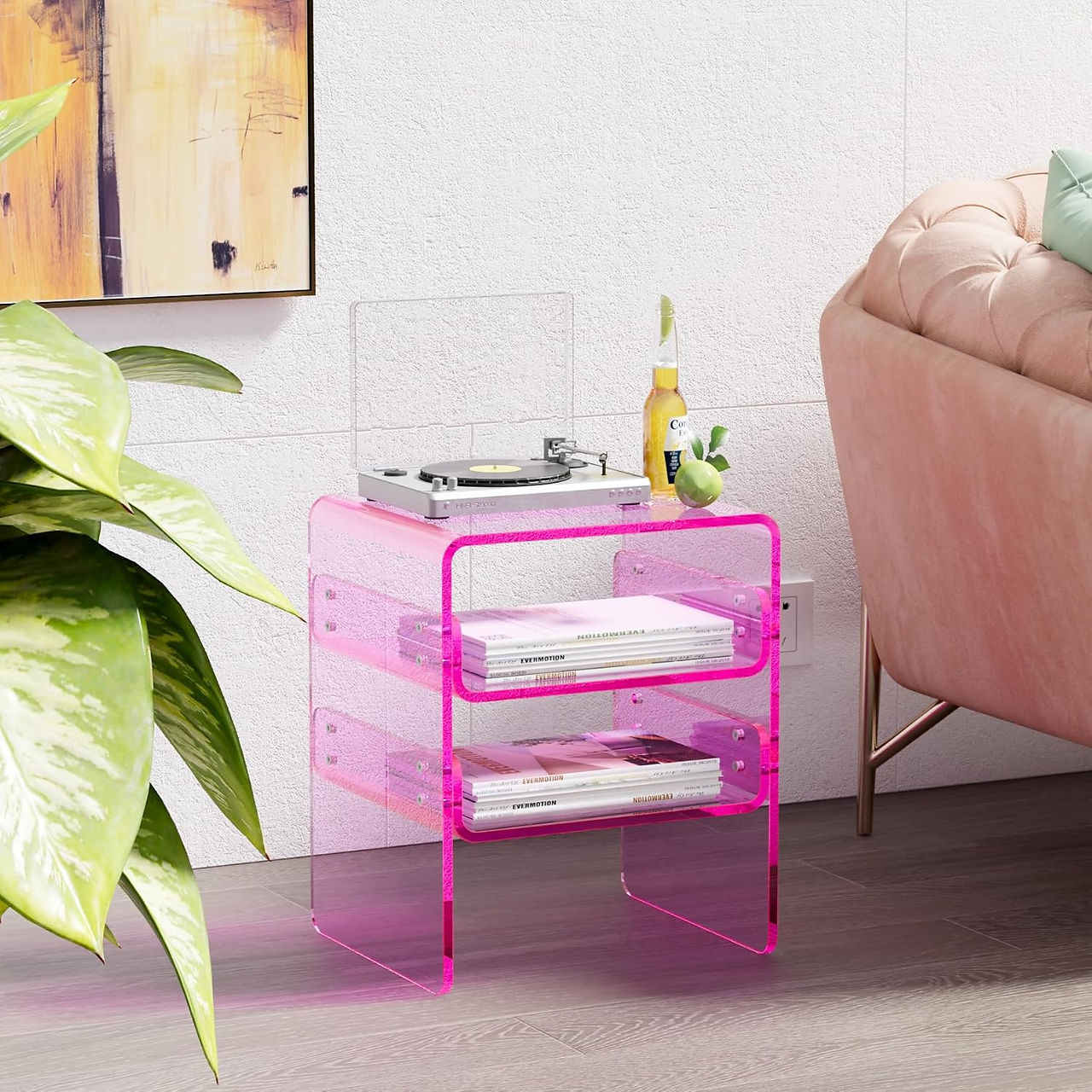 Bright pink acrylic side table with a retro record player and vinyl storage, styled in a cozy, pastel-toned living room—perfect for trippy or Y2K-inspired room decor.