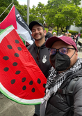 Chris at a Pro-Palestine protest with District 4 candidate Jeremy Smith holding a giant paper watermelon.