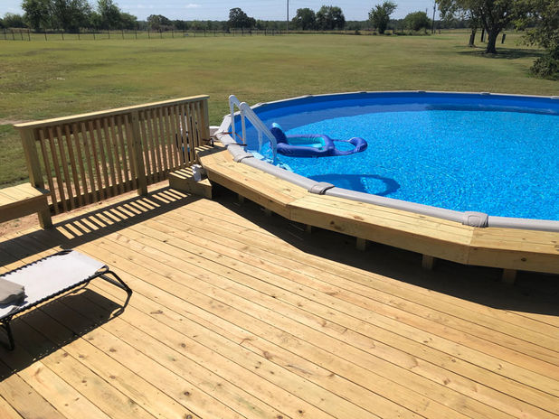 wood patio surrounding pool