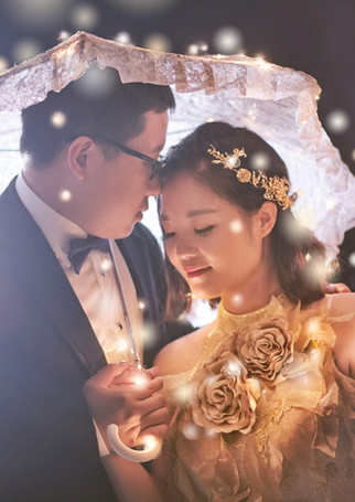 Couple holding umbrella with starry light effect at night