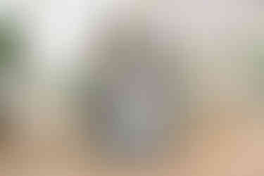 Happy family wearing color-coordinated Baju Kurung during a Raya studio photography session