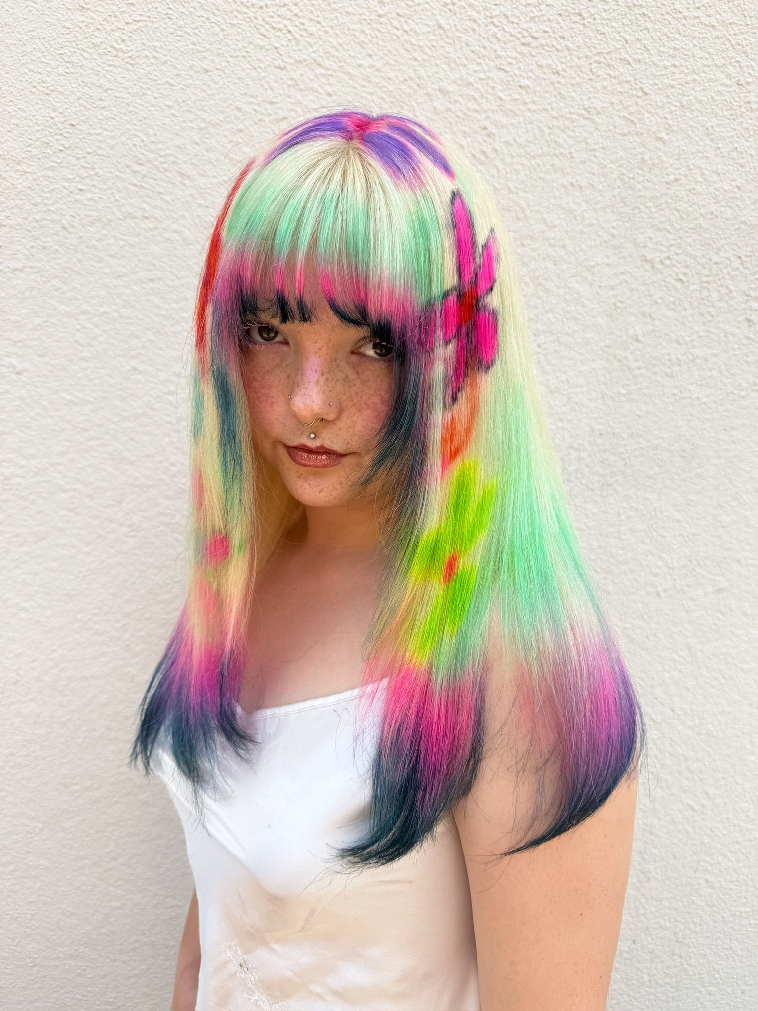 Model wearing Wild Flower Patch Wig with bright flowers and dip ends, facing forward