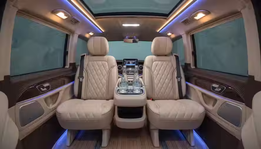 Eye-level view of a Mercedes-Benz V-Class interior with leather seats and soft cabin lighting