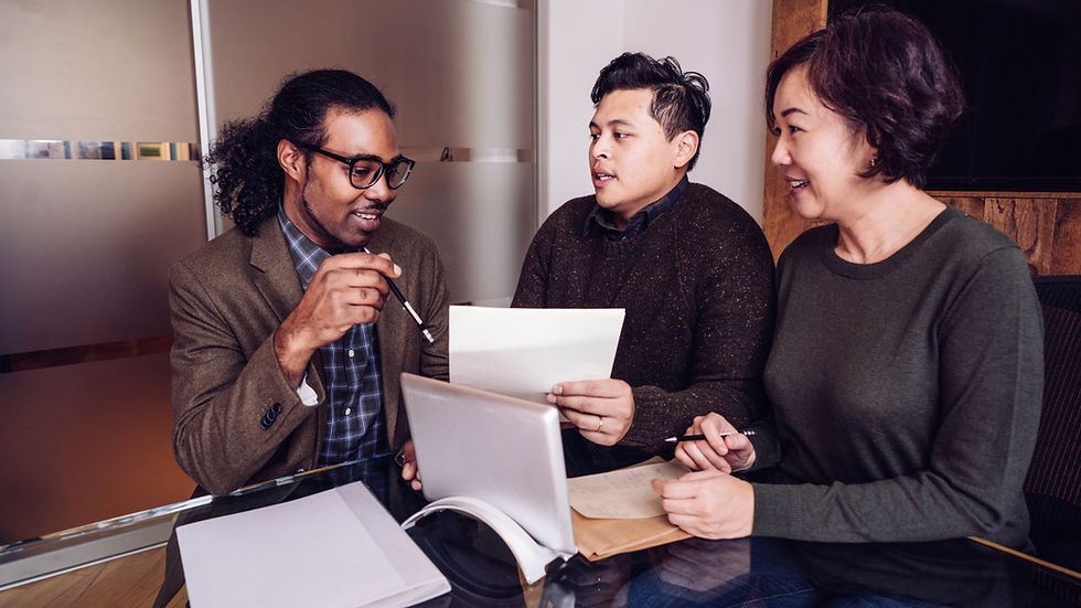 Three business people having a discussion at a desk