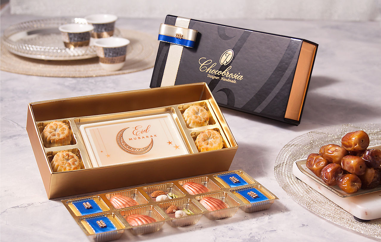 Black gift box with assortment of dates, chocolates and ma’amoul cookies for corporate gifting in Dubai